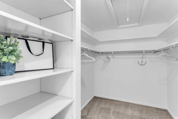 White shelving system with adjustable shelves and integrated hanging rods