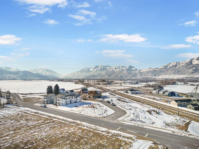 Expansive mountain range backdrop framing a rural landscape with residential structures
