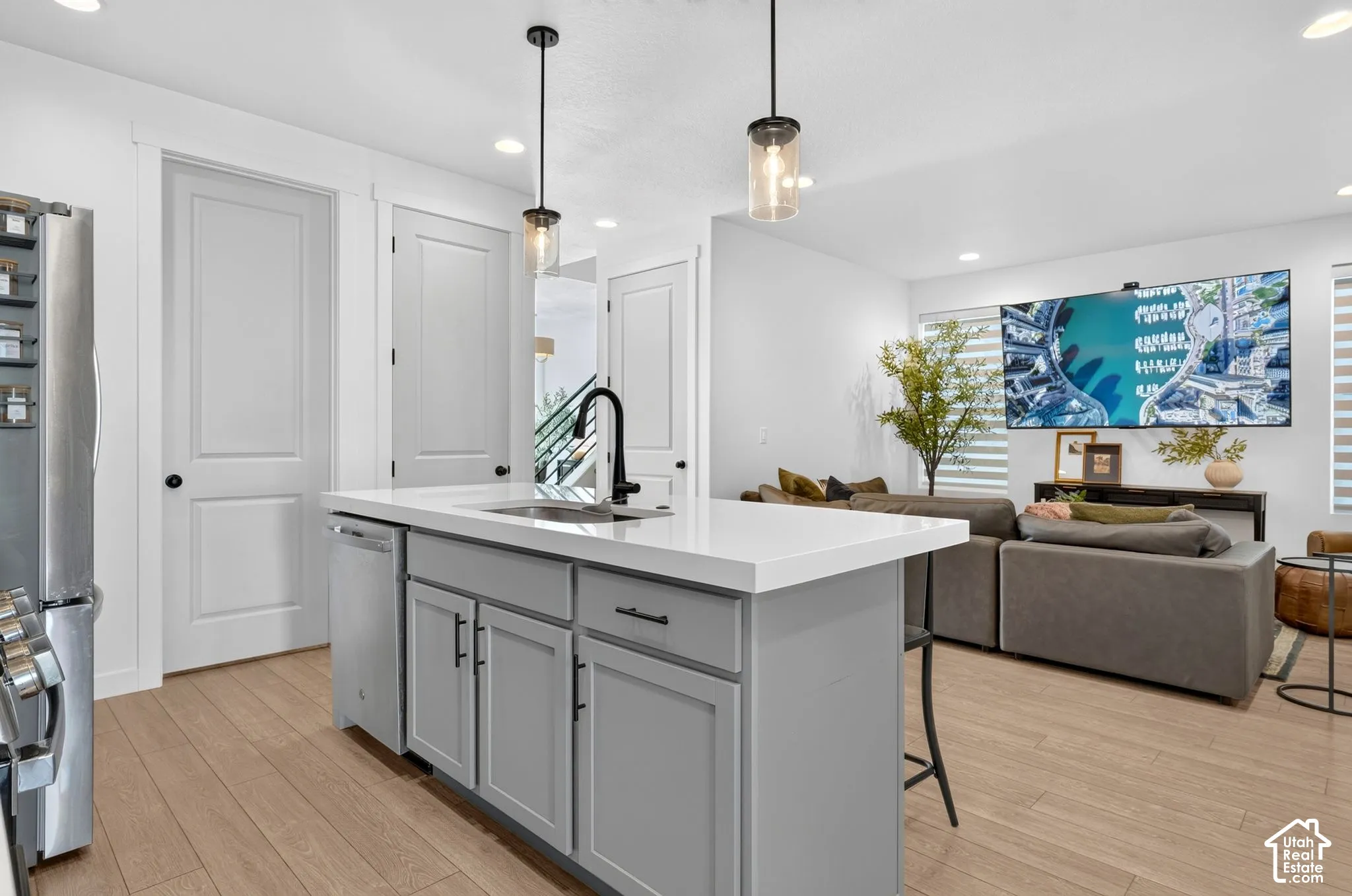 Kitchen island with a white countertop and gray cabinetry