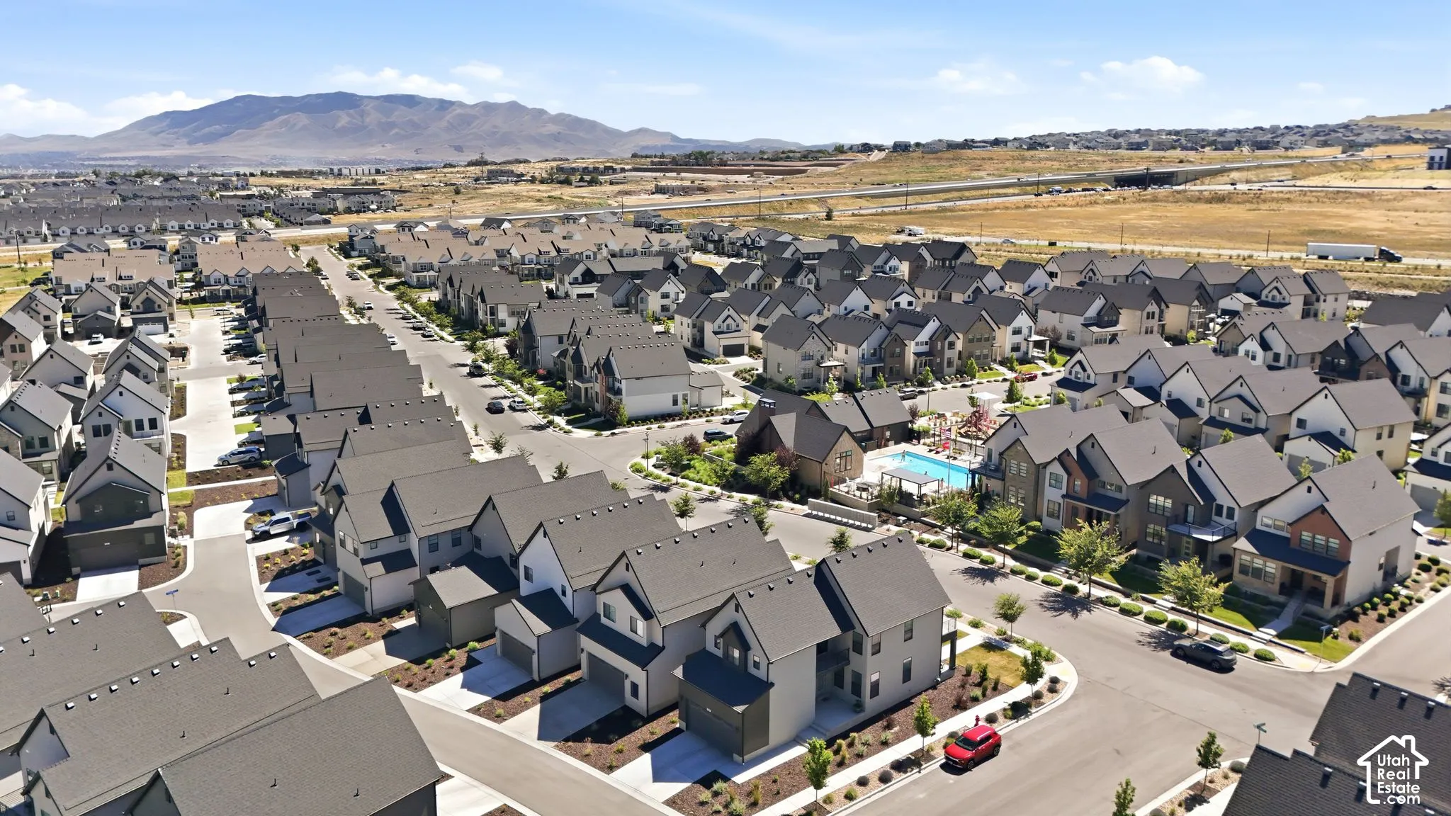 Expansive aerial perspective showcasing a residential community with contemporary architecture and dark-toned roofing