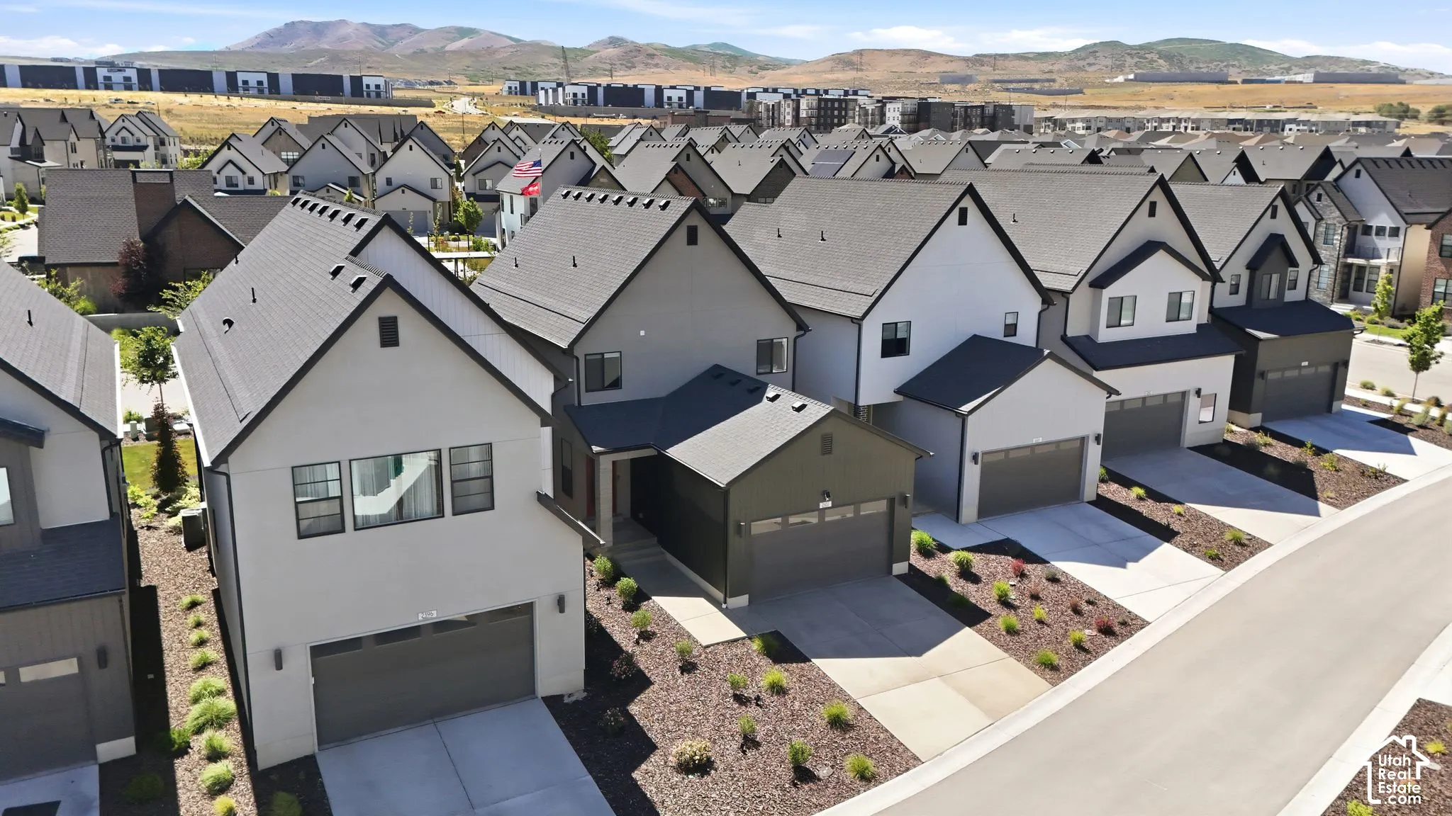 Contemporary residential streetscape featuring gabled roofs and varied exterior finishes