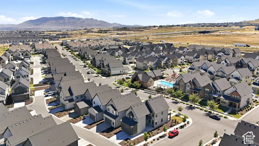 Expansive aerial perspective showcasing a residential community with contemporary architecture and dark-toned roofing