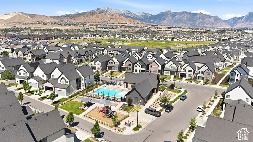 Expansive residential community featuring a variety of contemporary-style homes with dark-pitched roofs and light-colored siding