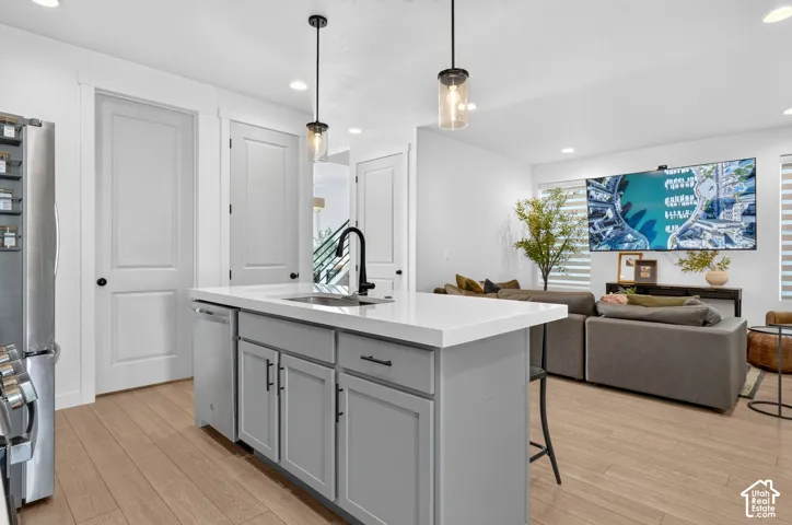 Kitchen island with a white countertop and gray cabinetry