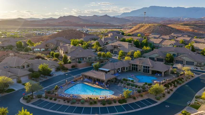 Community pool area featuring two distinct pools, a covered lounging area.