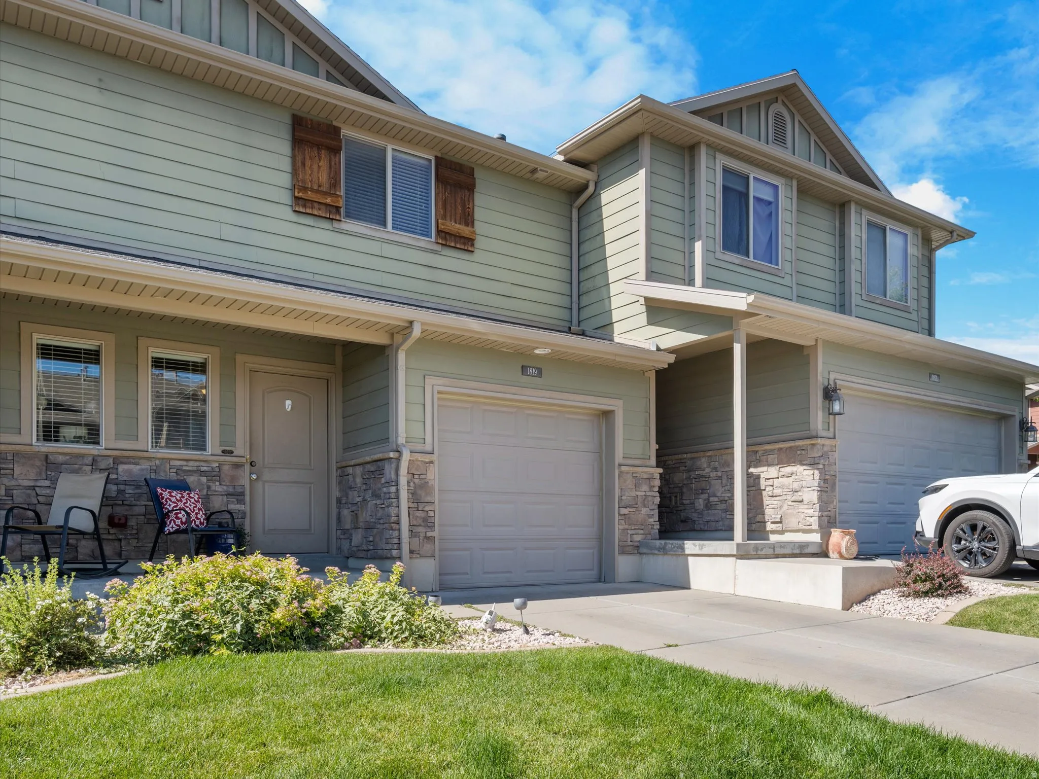 Light green siding exterior with stone veneer accents