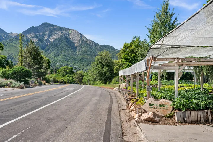Expansive plant nursery featuring a shade structure, mature greenery, and a prominent "Hosta House" sign