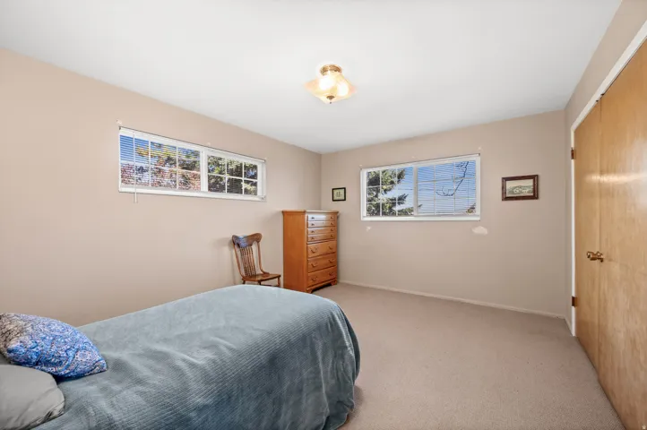 Neutral-toned walls and carpeted flooring define this room