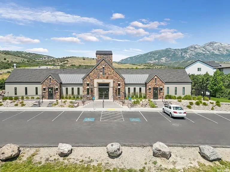Stone and stucco facade building featuring a central tower element