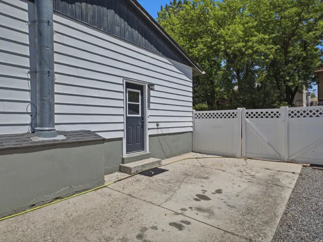 White horizontal siding exterior with a dark trim roofline