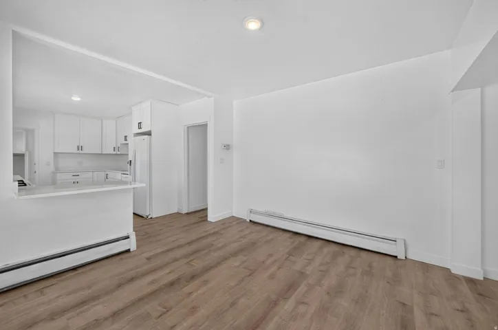 Open-concept living space with wood-finish flooring