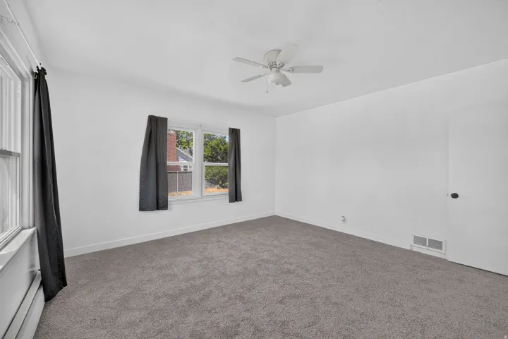 Neutral white wall finishes with grey carpet flooring