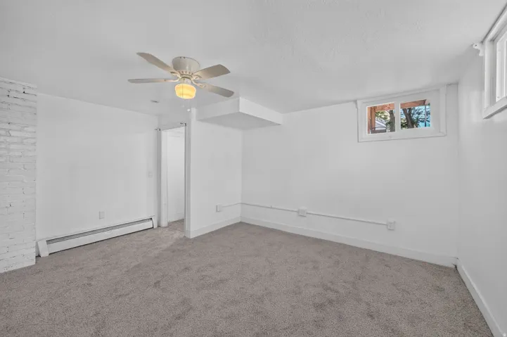 Spacious room featuring neutral carpeting and white walls