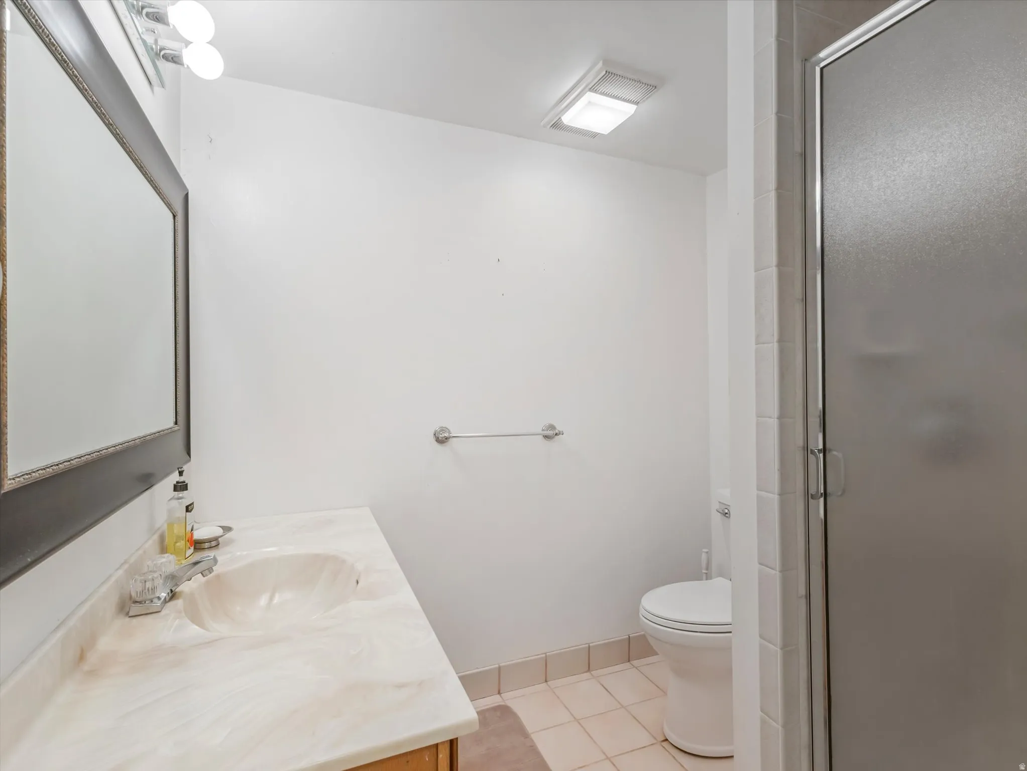 Bathroom featuring a vanity with an integrated sink and light-toned countertop