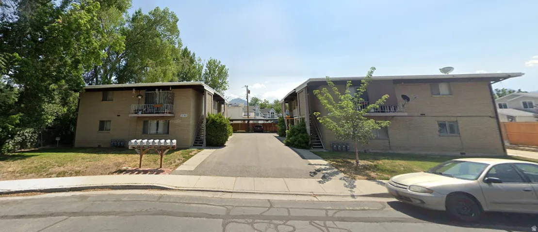 Two two-story apartment buildings with brick facades and individual balconies