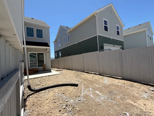 Private fenced yard with concrete patio, ideal for outdoor living