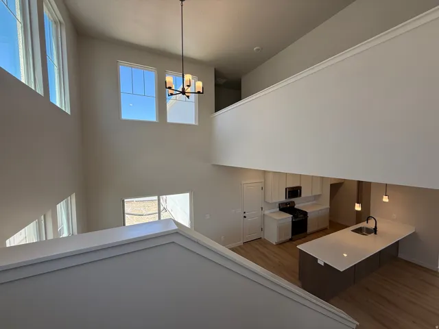 Two-story great room featuring high ceilings and multiple windows