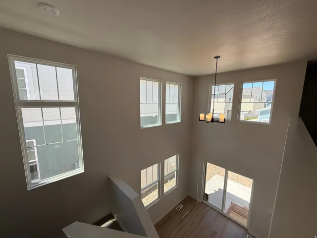 Two-story living area featuring a vaulted ceiling and an abundance of windows