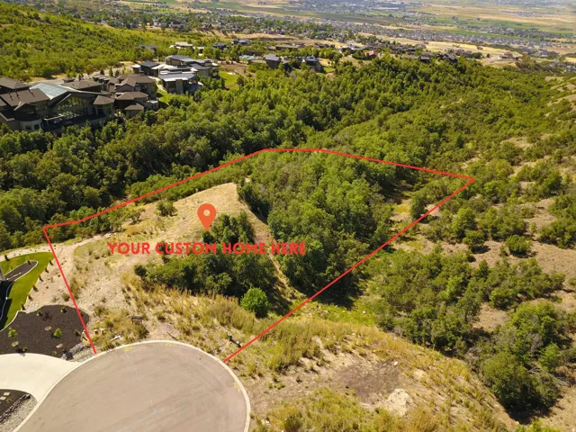 Generous residential lot featuring natural hillside terrain and mature trees