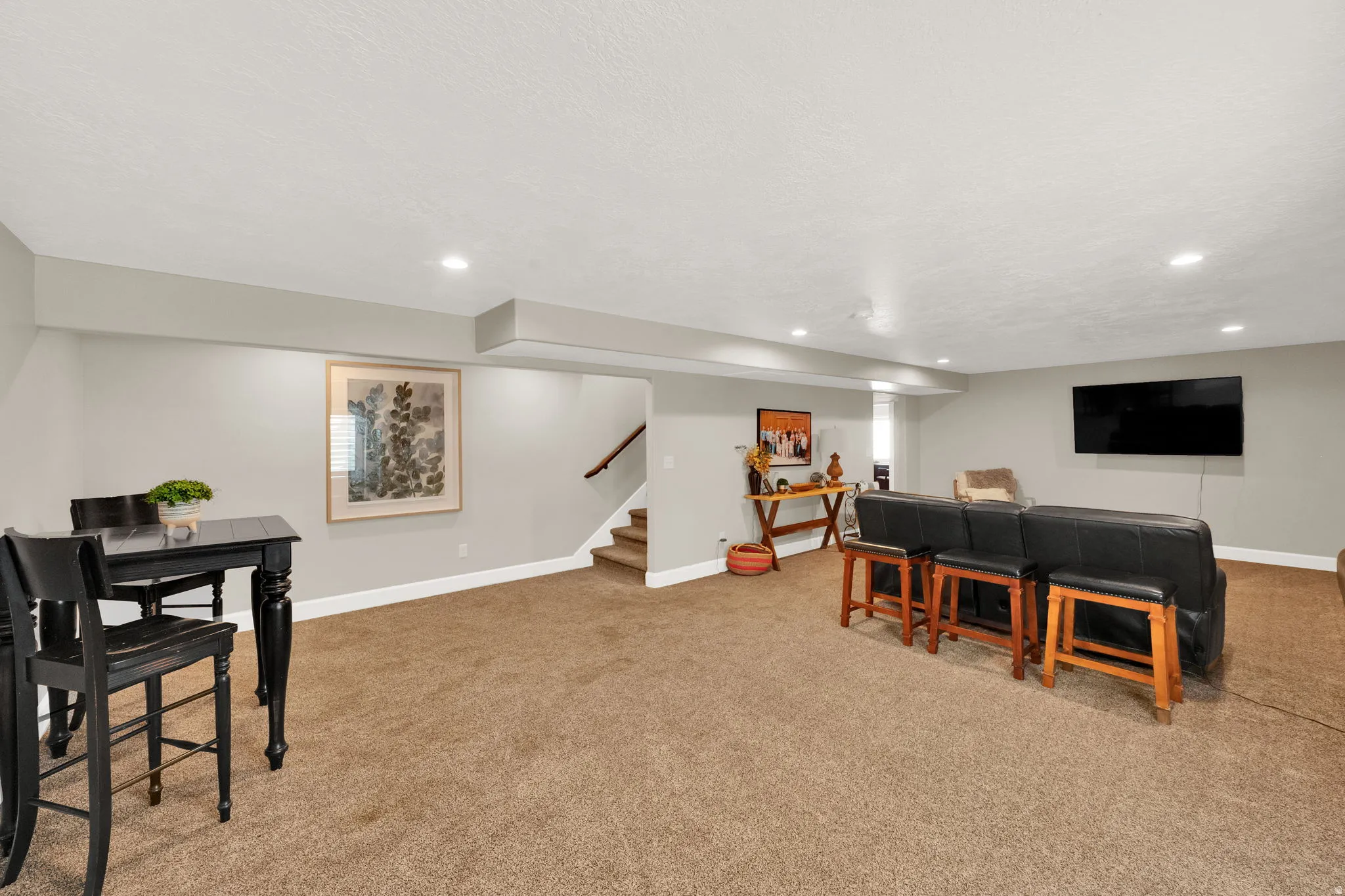 Spacious interior room featuring light gray walls, recessed lighting, and a textured ceiling