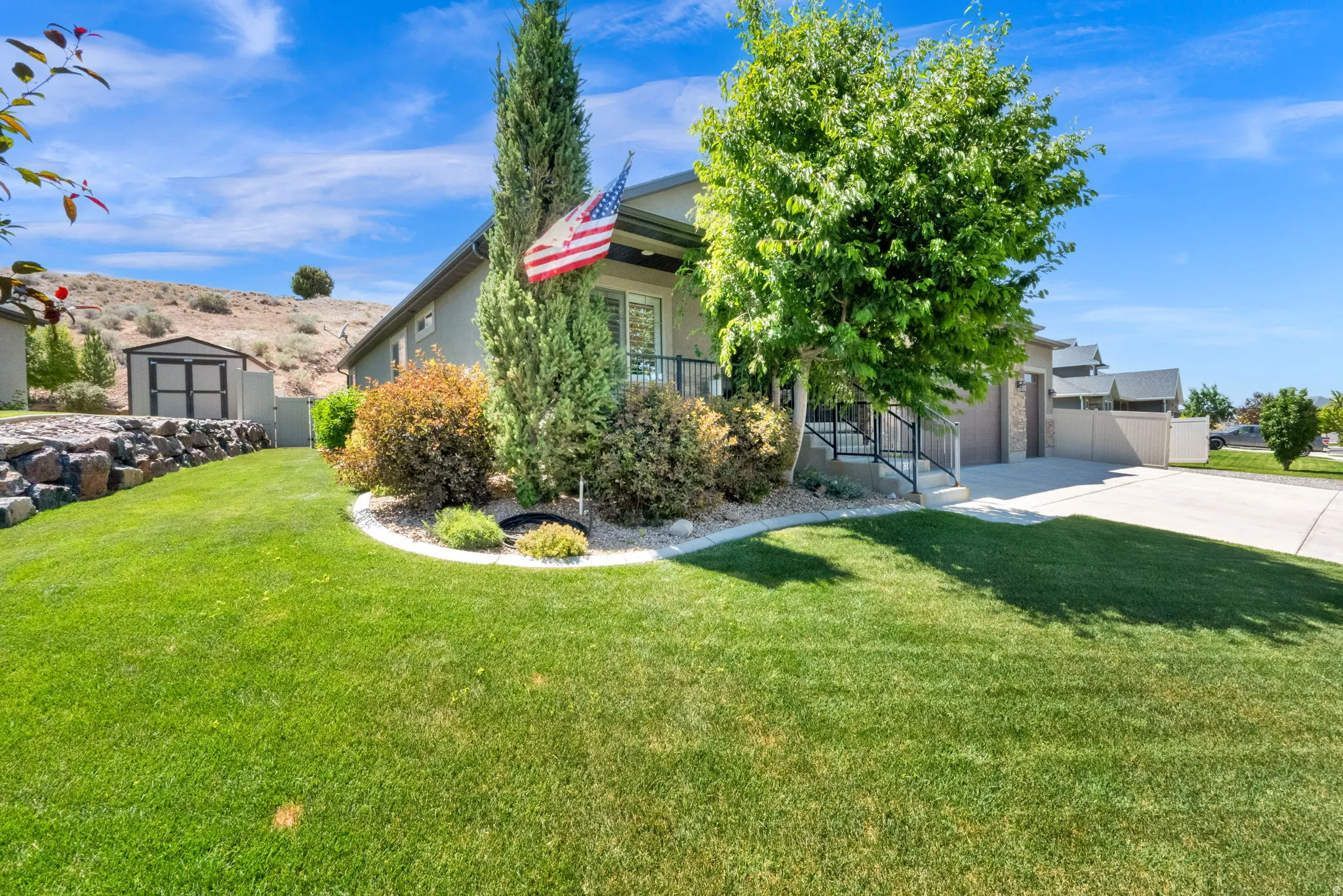 Manicured front lawn with established landscaping