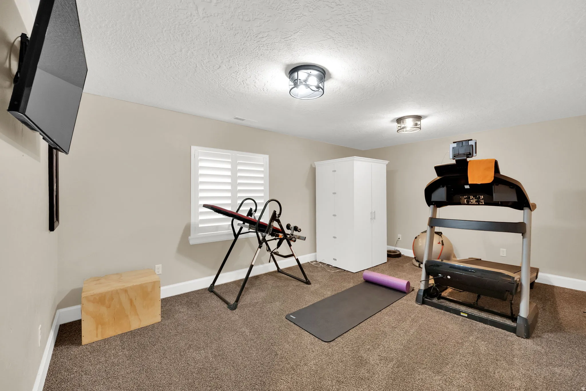 Carpeted room with neutral wall paint and white baseboards