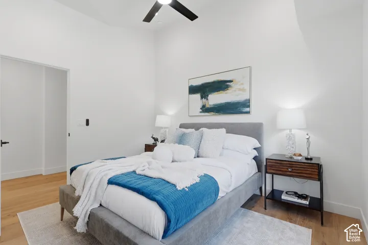 Light wood-finish flooring complements the crisp white walls and vaulted ceiling