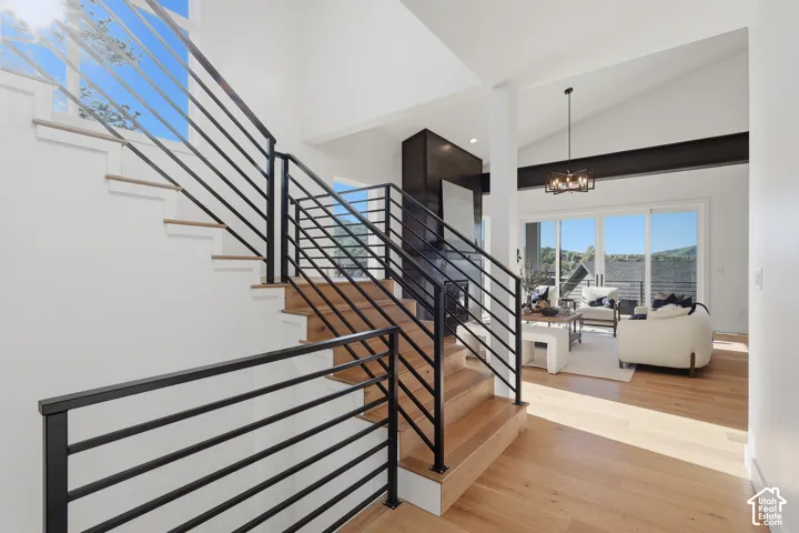 Modern staircase with black metal railings and natural wood-finish treads