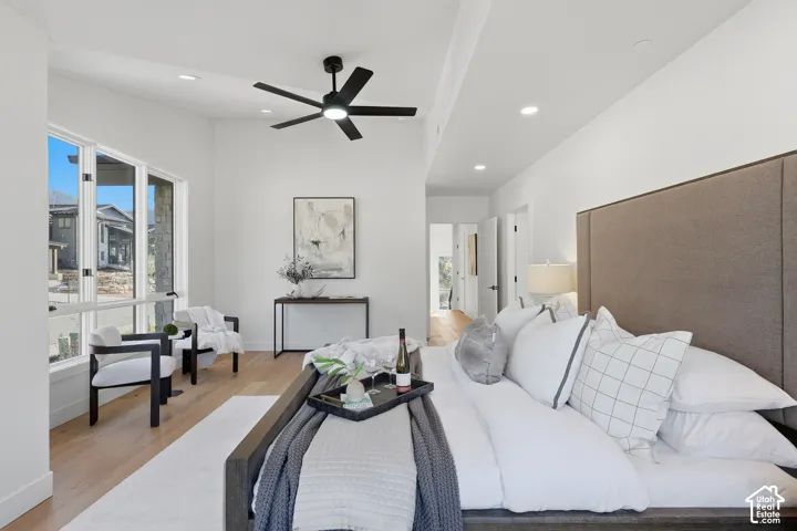 Spacious room with light wood-finish flooring and ample natural light from large windows