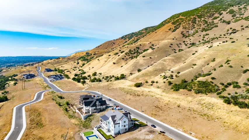 Expansive hillside development featuring multiple residential properties and paved roads