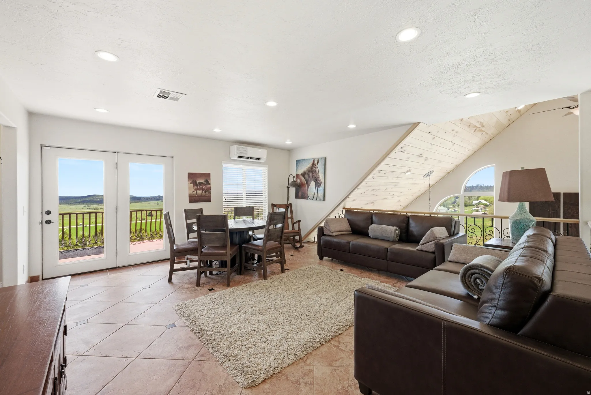 Spacious living area featuring tile flooring and recessed lighting