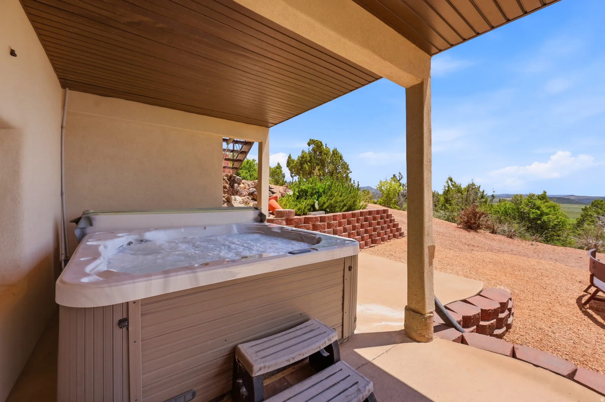 Covered patio featuring a built-in hot tub