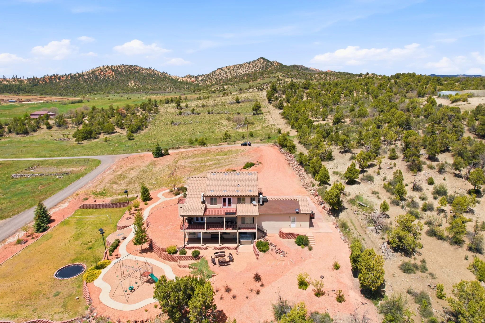 Expansive property featuring a multi-story residence with multiple balconies and a large outdoor patio area