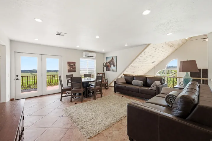 Spacious living area featuring tile flooring and recessed lighting