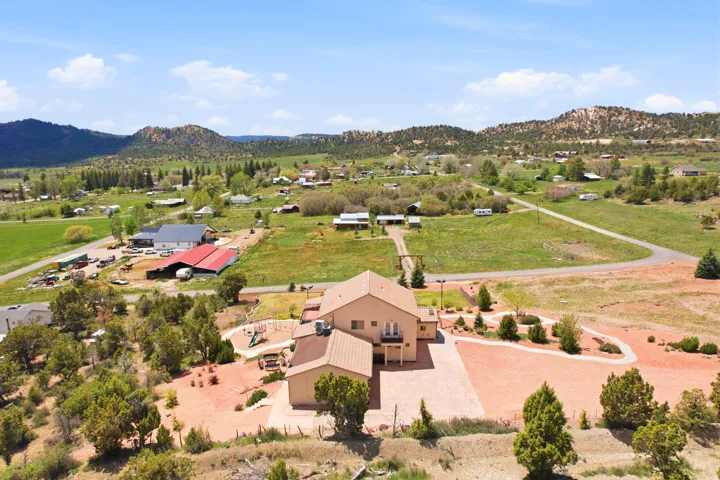 Expansive property featuring a stucco-exterior residence with a multi-level design and a covered entry