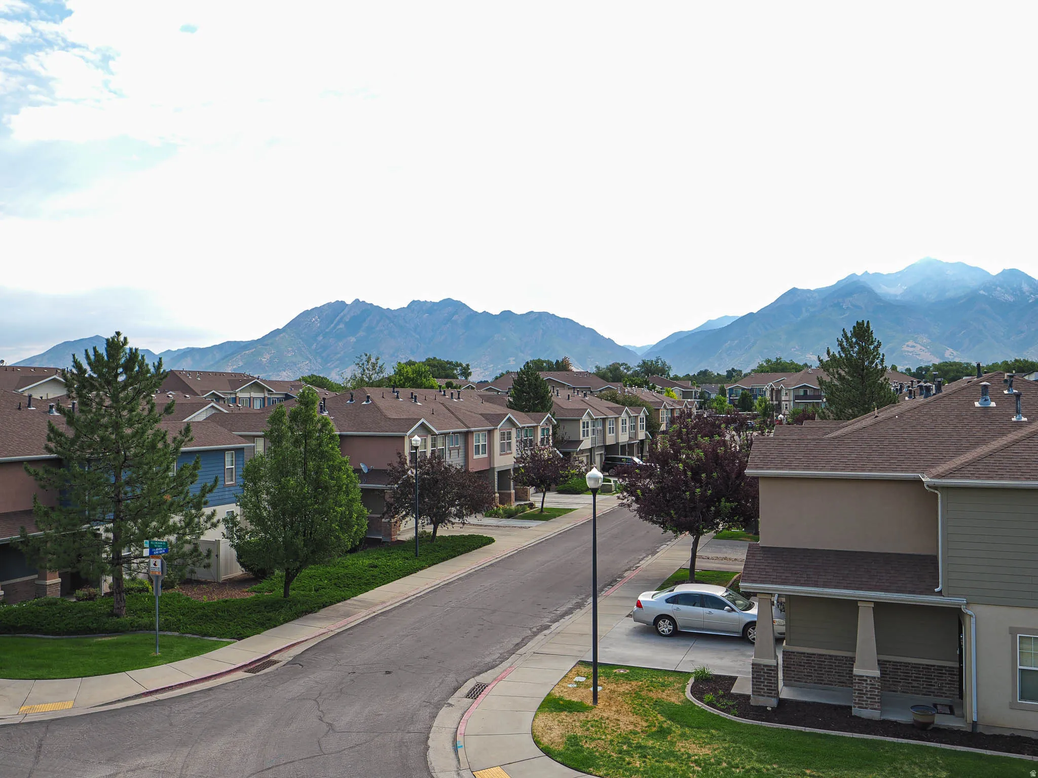 Residential streetscape featuring townhomes with mountain scenery