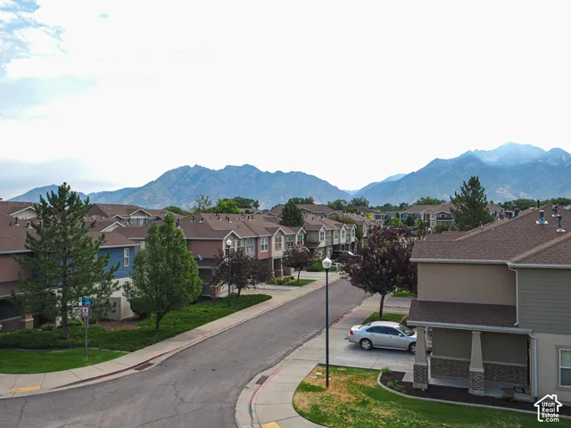 Residential streetscape featuring townhomes with mountain scenery