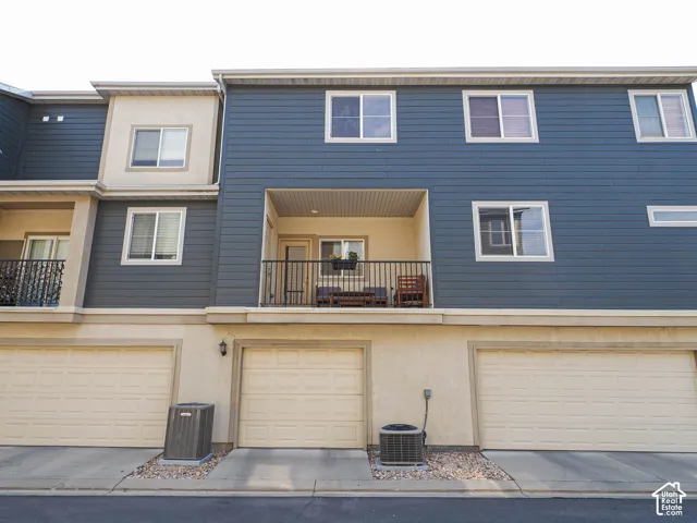 Multi-level exterior with blue siding and stucco finishes