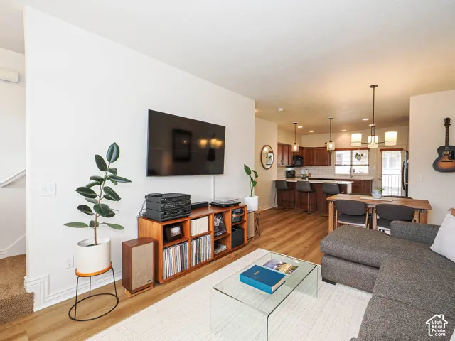 Open-concept living area featuring wood-finish flooring