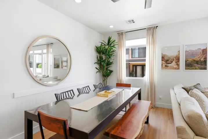 Bright dining area featuring wood-finish flooring and a contemporary ceiling fan