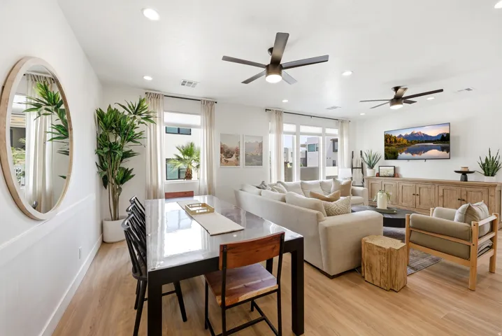 Open-concept living space featuring wood-finish flooring, recessed lighting, and white walls