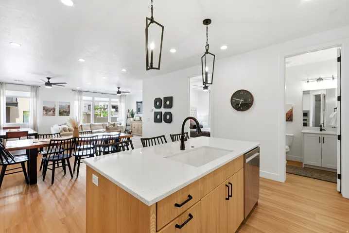 Contemporary kitchen island with a white solid surface countertop, integrated sink, and matte black faucet