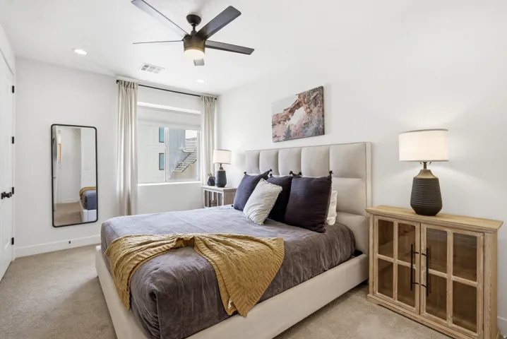 Bedroom featuring a large window with privacy blinds, recessed lighting, a ceiling fan, and light-colored carpeting