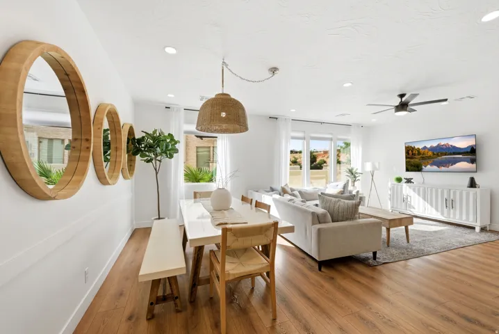 Open-concept living area featuring wood-finish flooring, recessed lighting, and a contemporary ceiling fan