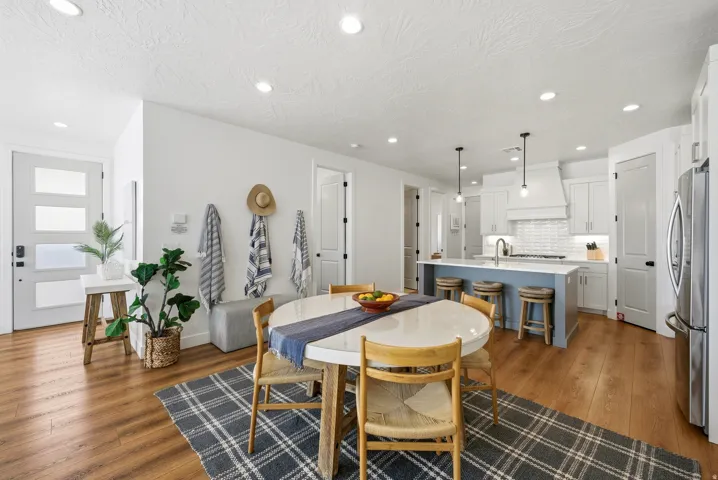 Open-concept living space featuring wood-finish flooring and recessed lighting