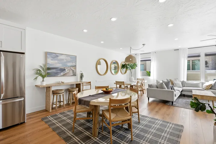 Open-concept living space featuring wood-finish flooring, recessed lighting, and white walls