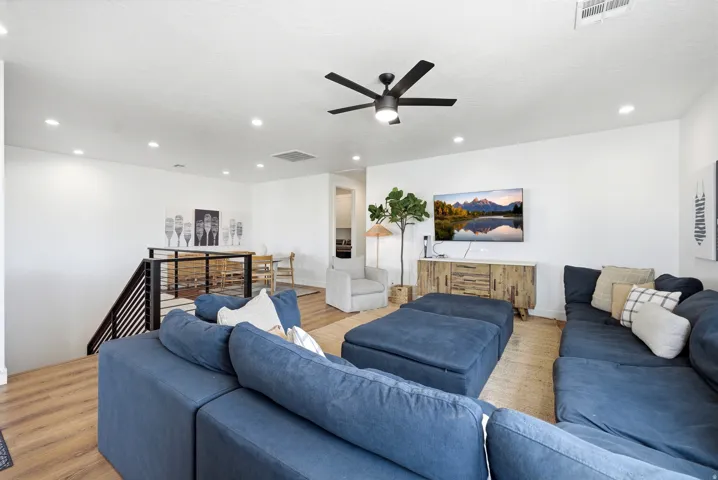 Open-concept living space featuring wood-finish flooring and a white wall finish
