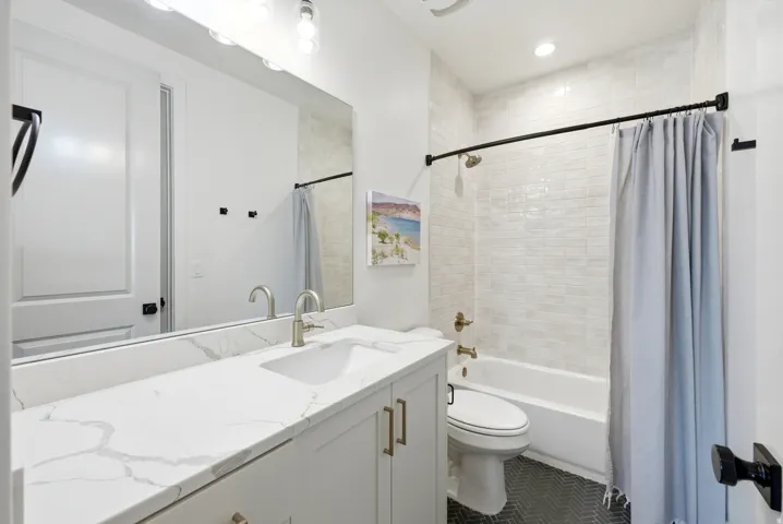 Bathroom featuring a single vanity with a white countertop and undermount sink