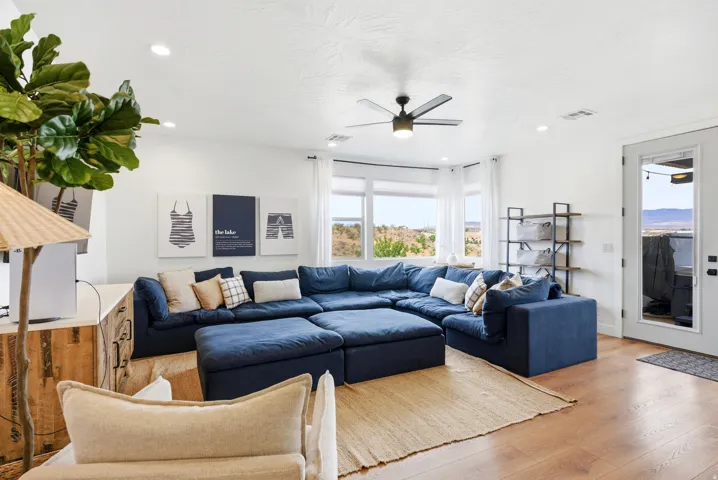 Spacious living area featuring wood-finish flooring, recessed lighting, and a ceiling fan