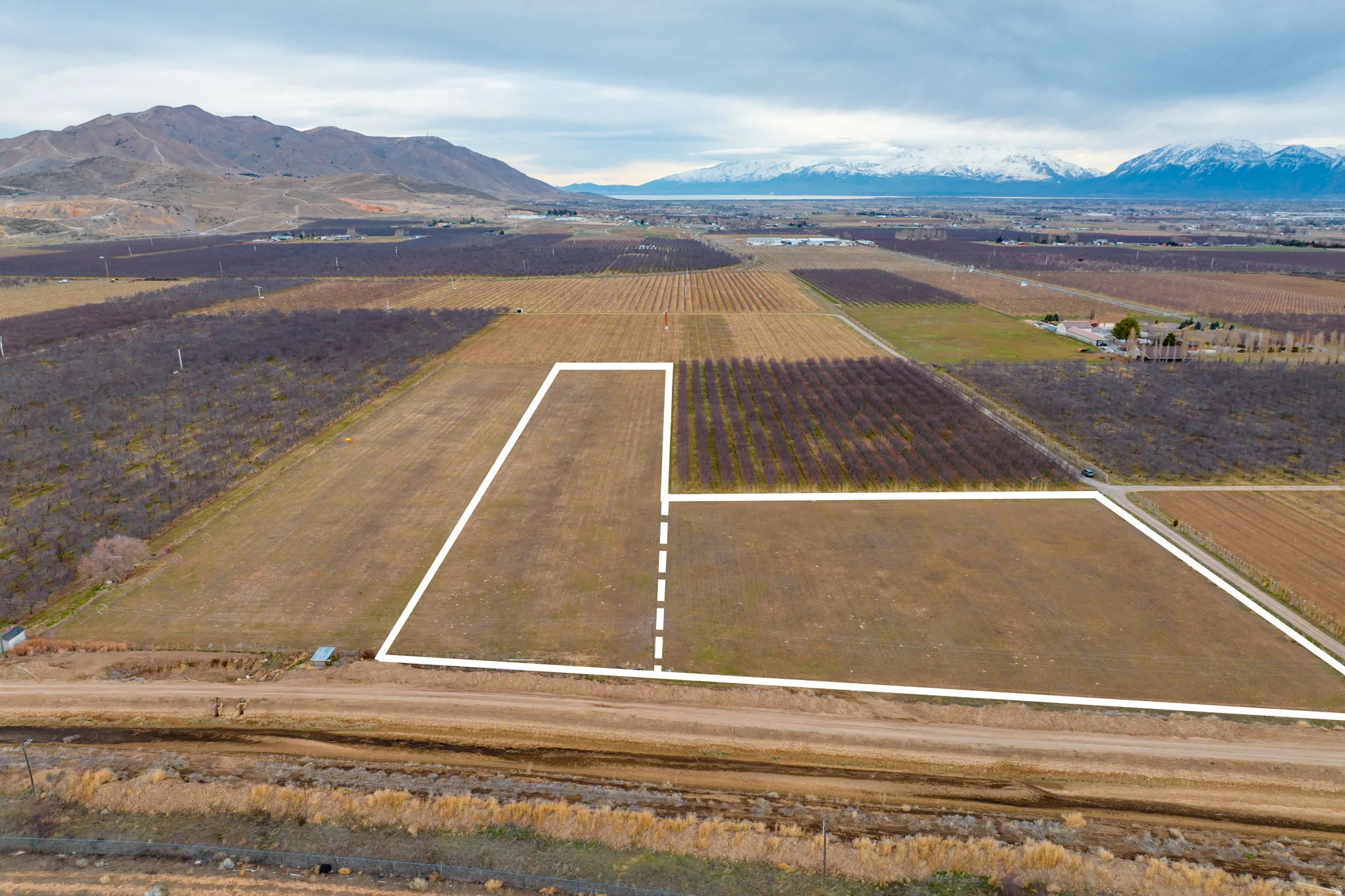Expansive agricultural land featuring a clear, level terrain with visible boundary lines